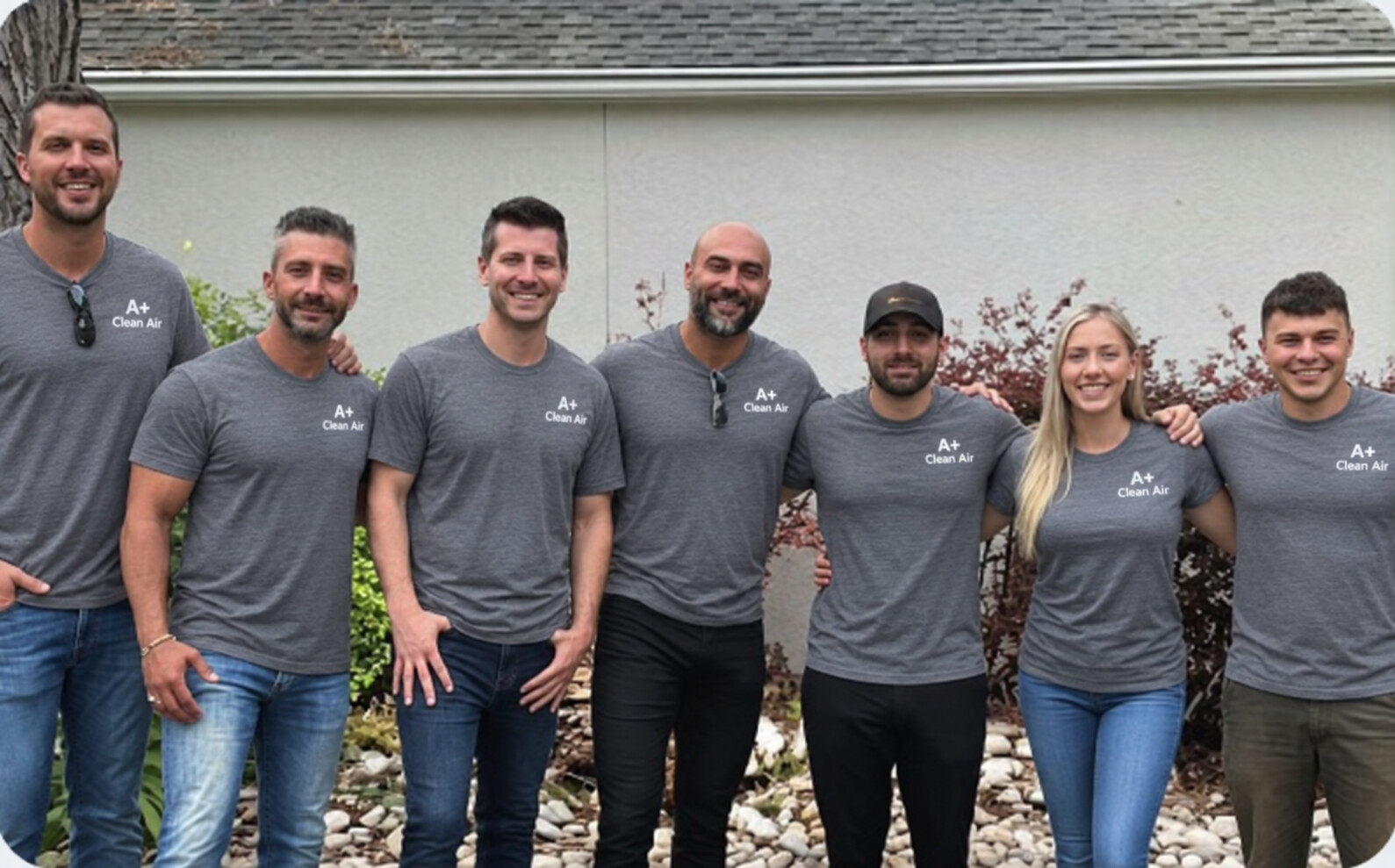 The A+ Clean Air service team in branded gray shirts